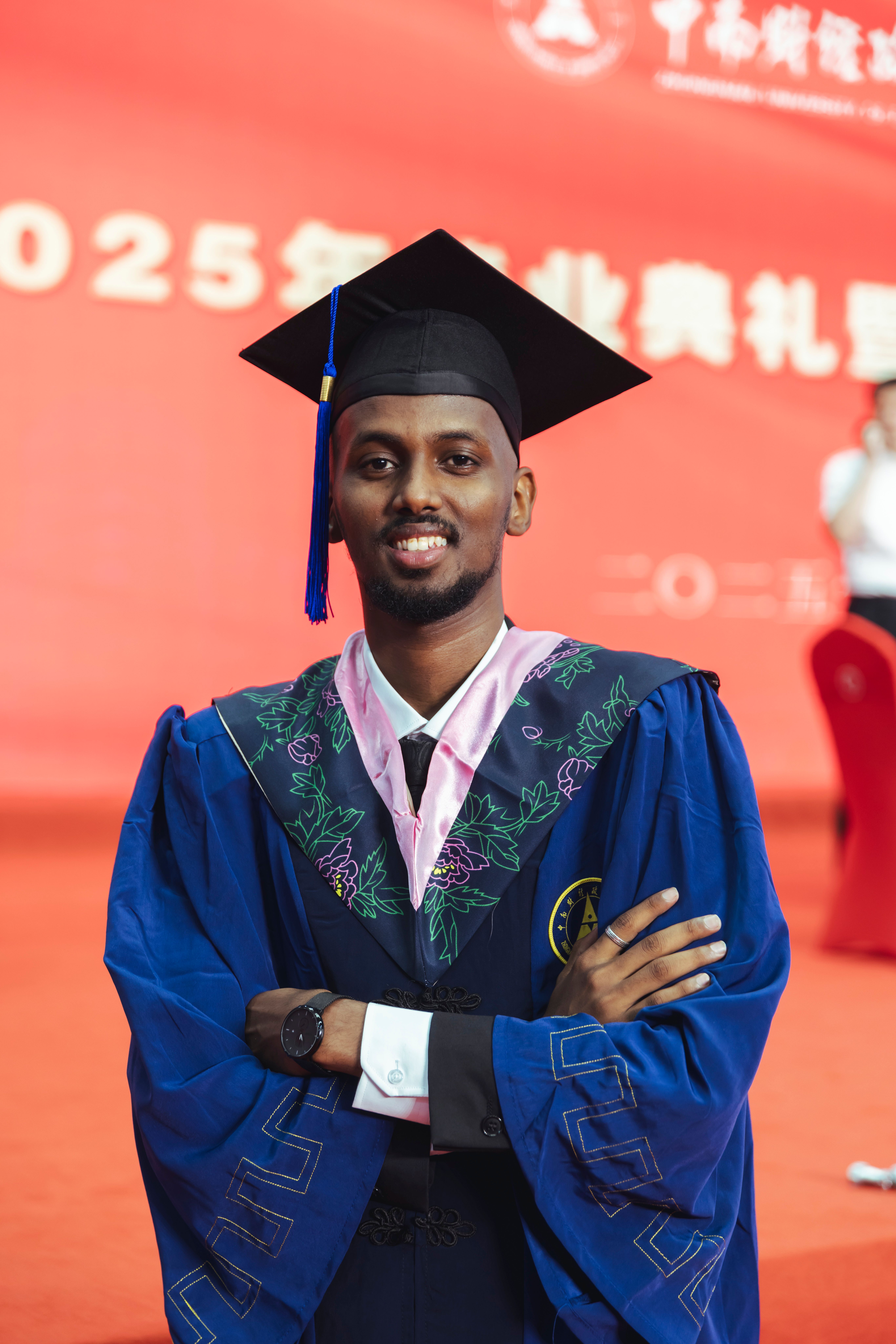 Smiling Graduate at Ceremony in Blue Gown · Free Stock Photo