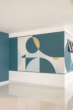 Light-filled, modern interior featuring abstract geometric wall art on blue and white walls.