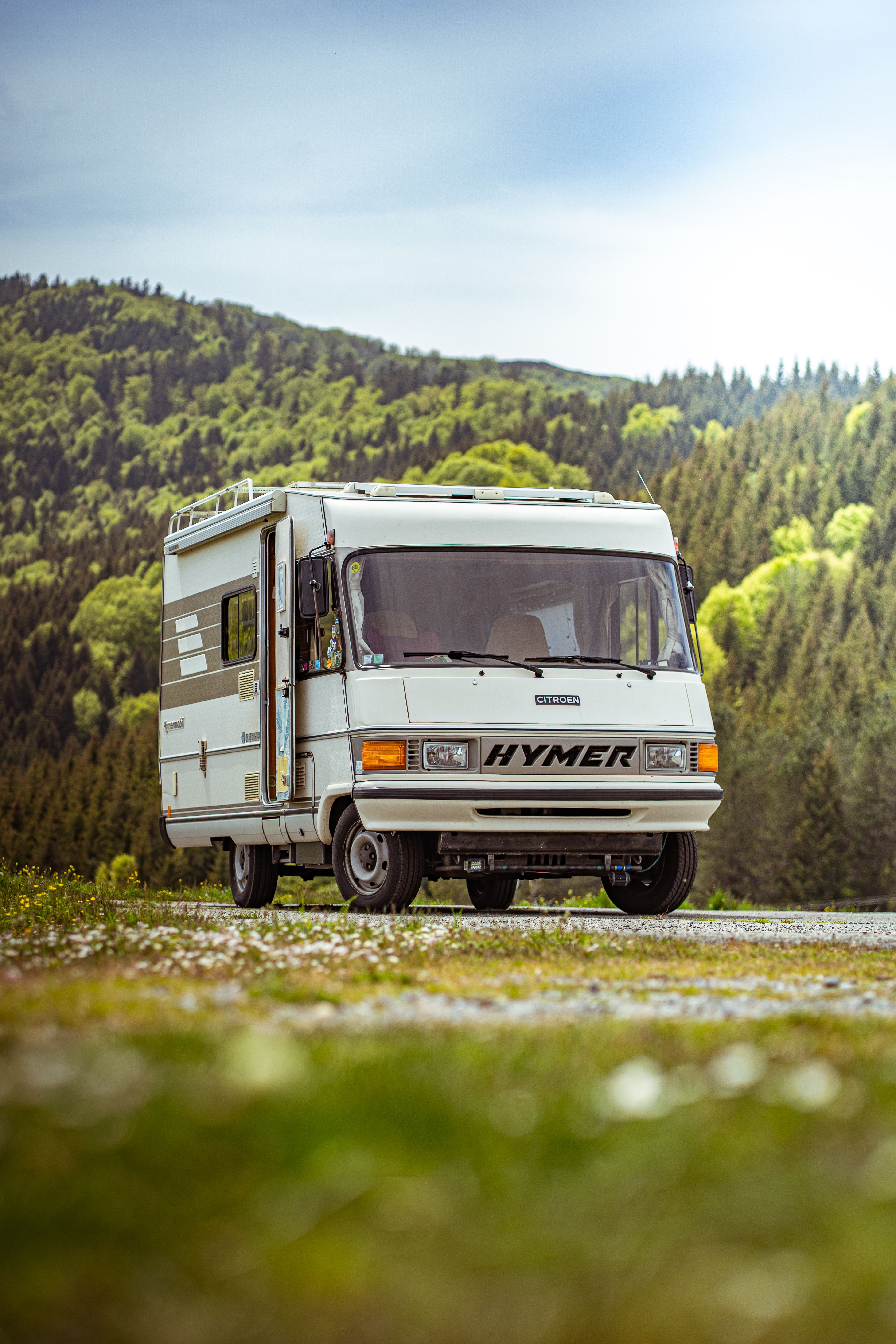Vintage Hymer RV amidst lush green landscape · Free Stock Photo