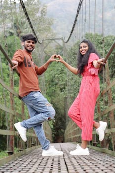 Couple Posing on Suspension Bridge in Nature