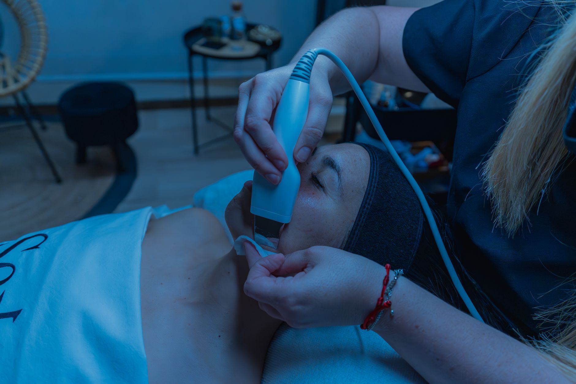 Close-up of a skincare treatment using advanced device in a spa setting.