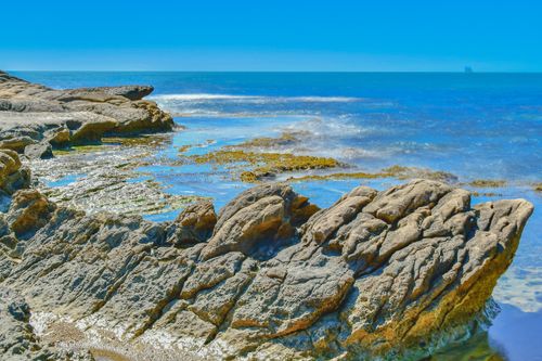 Free A breathtaking view of the rocky Mediterranean coastline in Alicante, España under a clear blue sky. Stock Photo