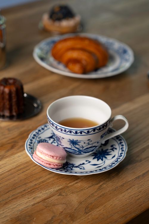Free A beautifully arranged wooden table with tea, macarons, and French pastries, creating an inviting setting. Stock Photo