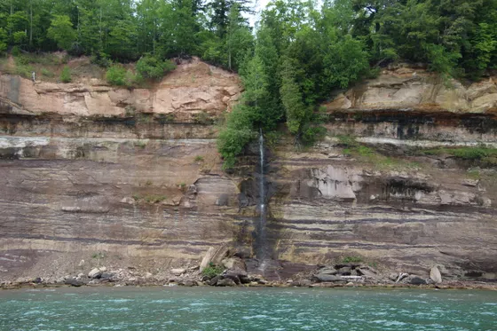 Spray Falls tumbling over the cliffs into Lake Superior