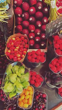 Colorful display of fresh fruits and garlic at a Paris market, showcasing vibrant urban life.