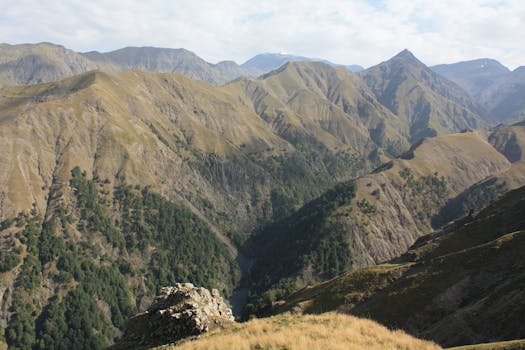 Captivating view of a vast mountain landscape, bathed in daylight and showcasing rugged beauty.