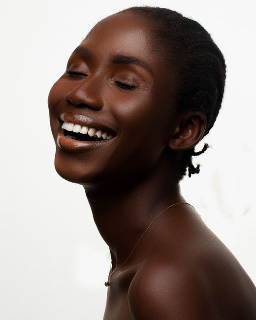 Woman with glowing, healthy skin using Pro skincare products