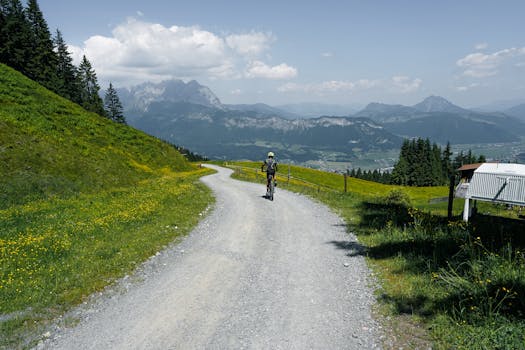 Cyclist riding on a scenic mountain trail among the Austrian Alps in Sankt Johann in Tirol.
