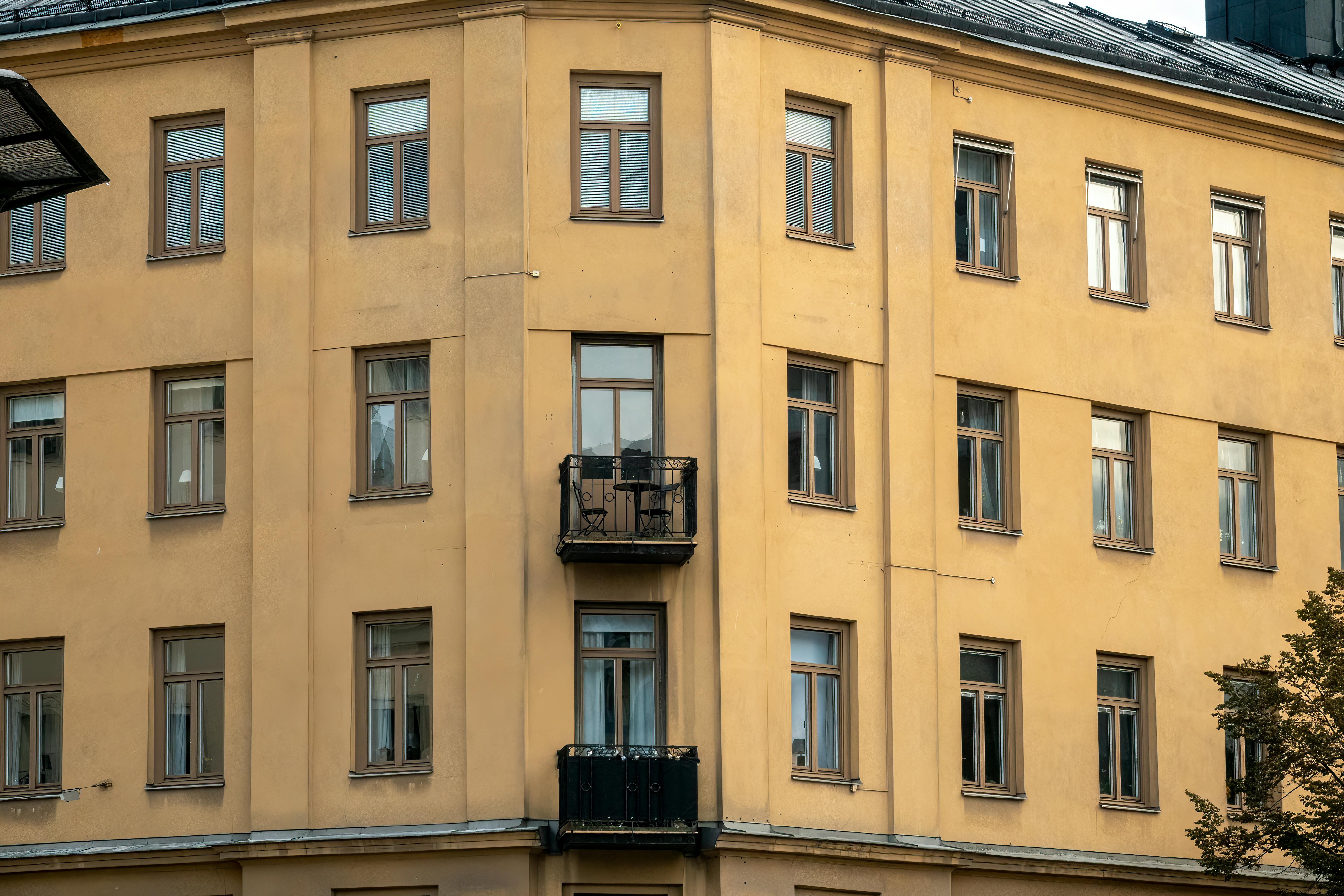 Yellow facade of a classic Swedish apartment building in Stockholm.
