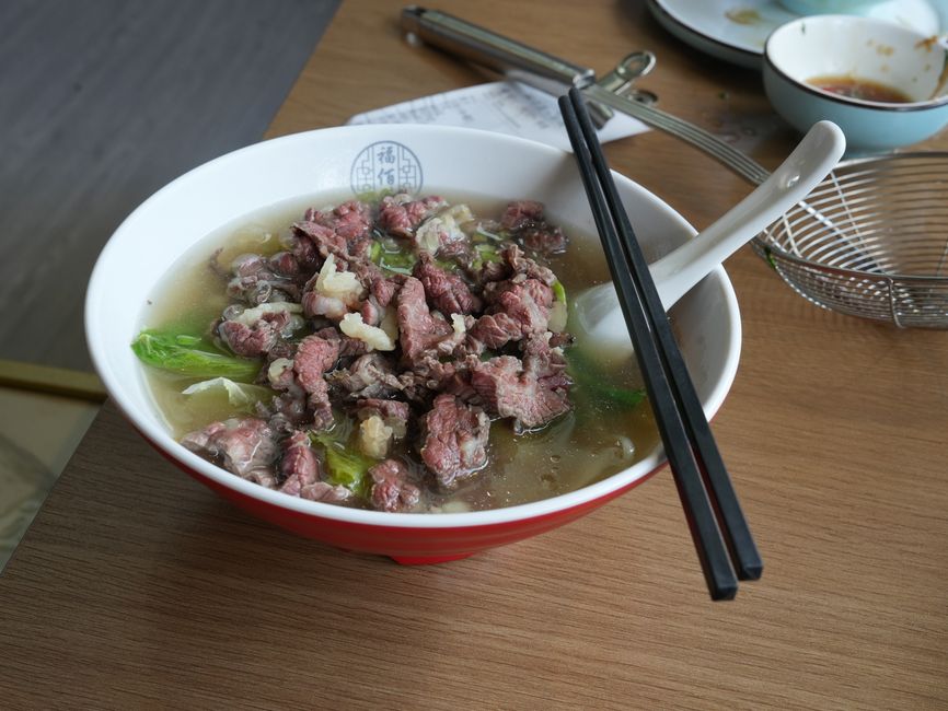 Close-up of a delicious bowl of Taiwanese beef noodles at a night market