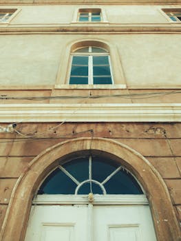 Low angle view of a historic building facade with arched windows in Istanbul, Türkiye.