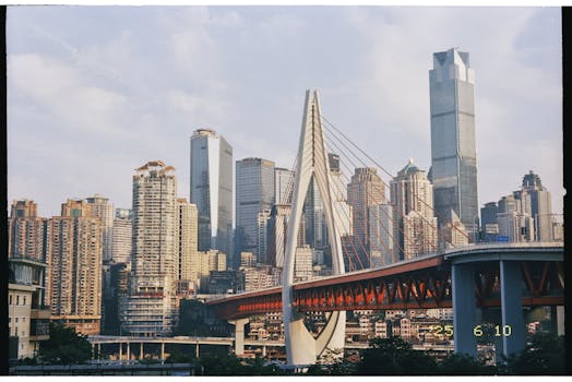 Stunning view of Chongqing skyline featuring Qiansimen Bridge and modern skyscrapers.