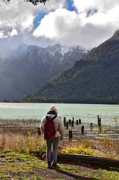 A traveler in Patagonia enjoys a stunning mountain and lake view.