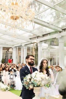 A joyful wedding ceremony in a beautifully decorated indoor venue in São Paulo, Brazil.