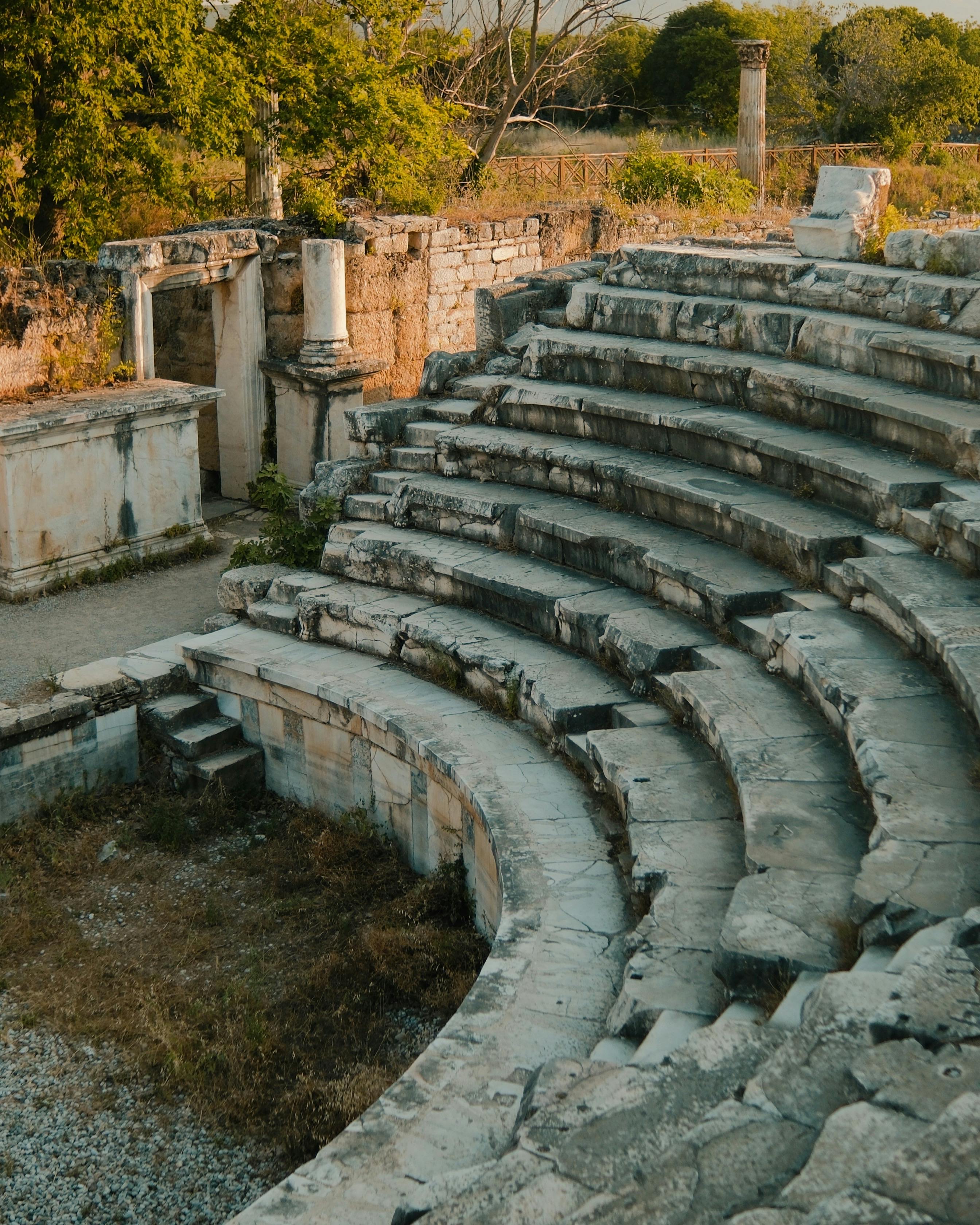Free Old stone amphitheater ruins nestled in a serene, natural setting. Stock Photo