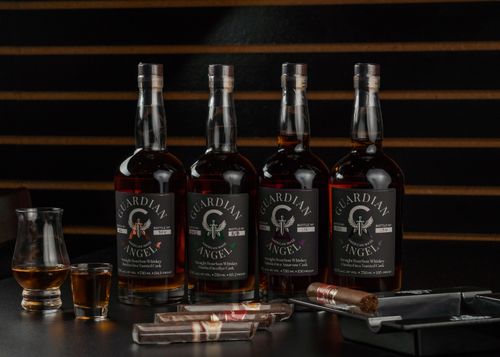 Free Four bottles of Guardian Angel bourbon with cigars at a New Orleans bar setting. Stock Photo