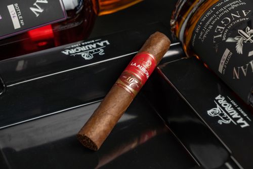 Free Close-up of a premium whiskey bottle and cigar set on a luxurious La Aurora tray. Stock Photo