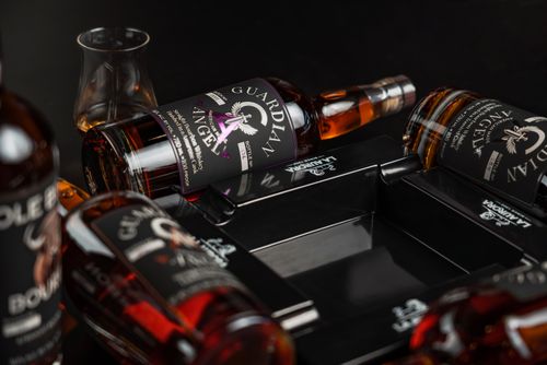 Free A premium display of craft bourbon bottles, including Guardian Angel, set elegantly in a New Orleans bar. Stock Photo