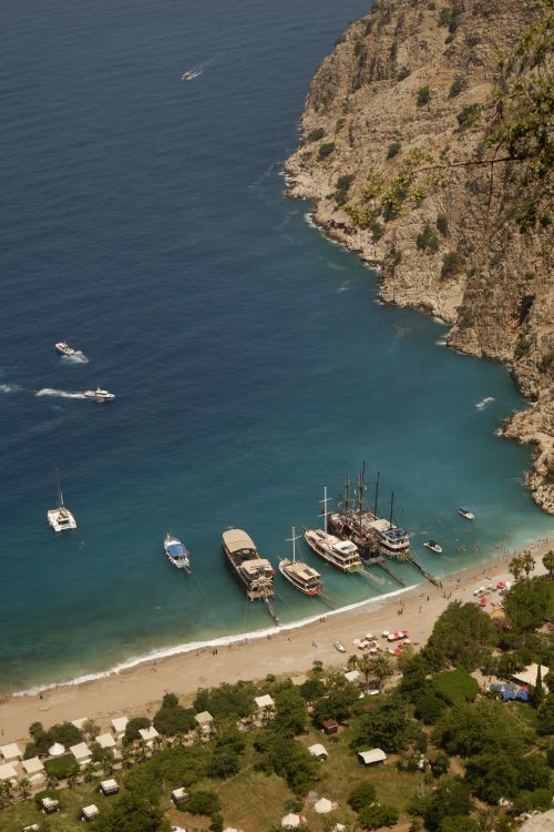 Aerial View of Boats Docked at Rocky Coastline Beach · Free Stock Photo