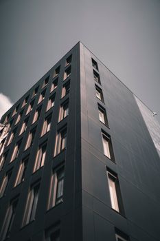 Low angle view of a modern building with sleek design against a clear sky.
