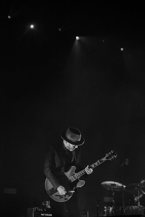 ステージでギターを弾く男