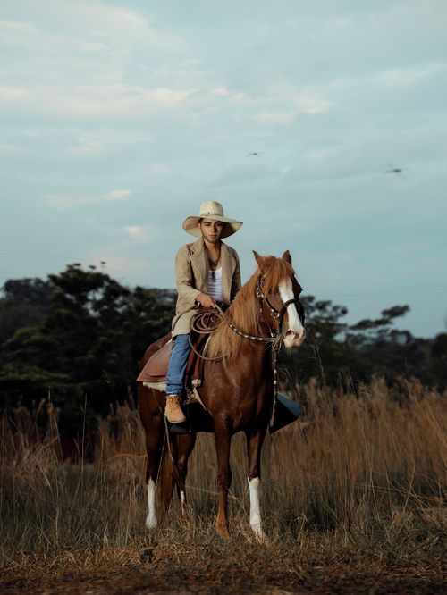 Free A woman riding a horse through the scenic grasslands of Tingo María, Peru. Stock Photo