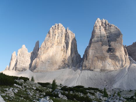 Stunning shot of Tre Cime di Lavaredo in the Dolomites, Italy under a clear blue sky.