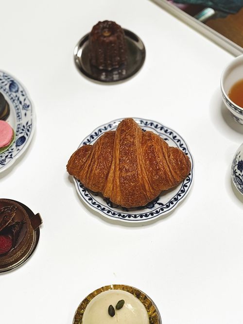 Free A delicious assortment of French pastries including croissant and macarons on a table in a Berlin café. Stock Photo