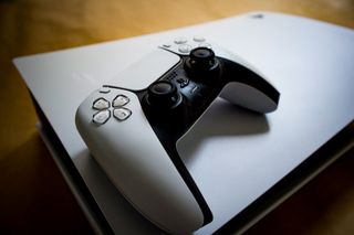 A PlayStation 5 controller resting on the console