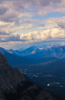 Stunning view of the Rocky Mountains with dramatic clouds and vast landscape.