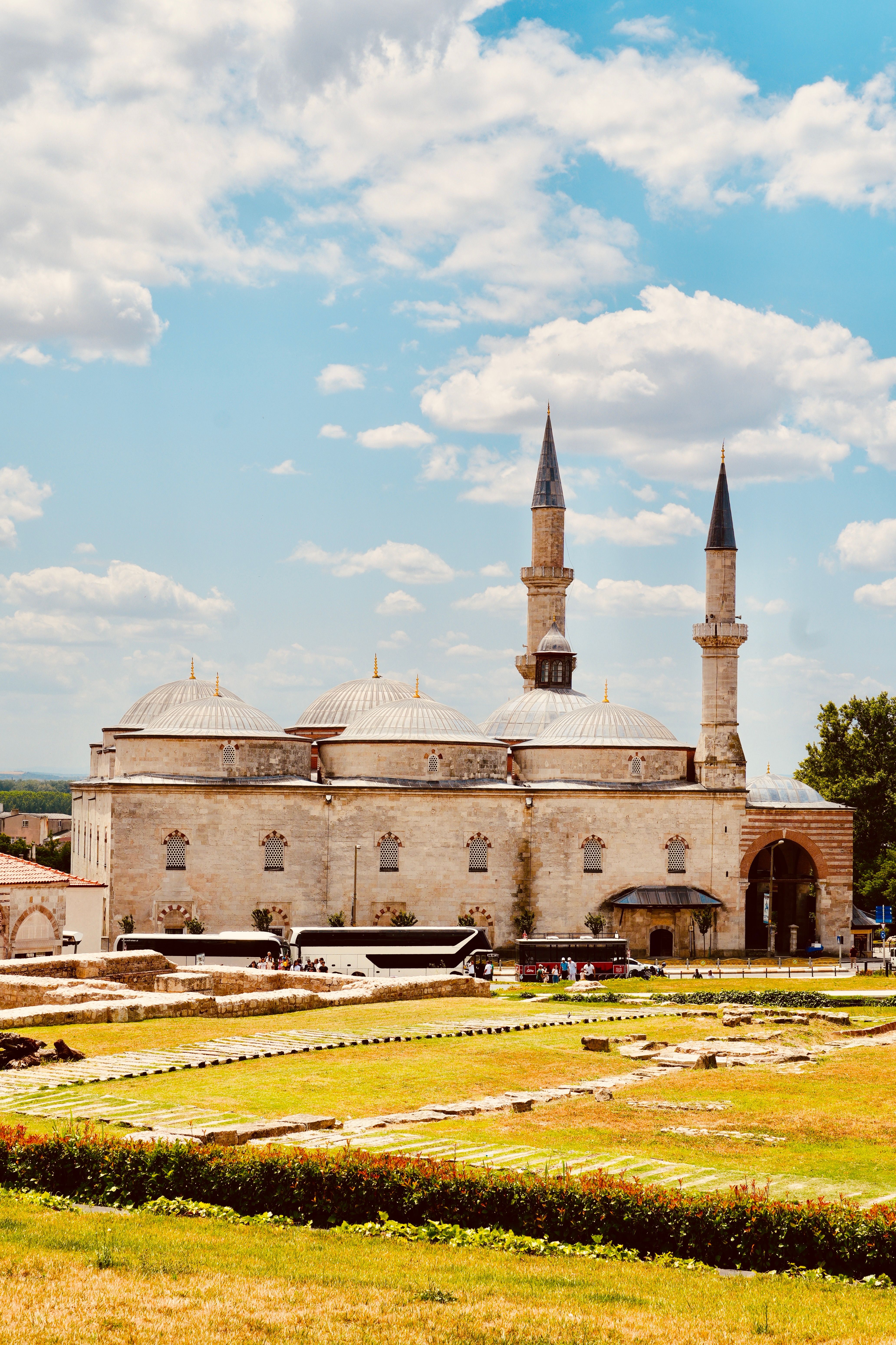 Stunning mosque under a bright summer sky, showcasing elegant architecture and lush surroundings.
