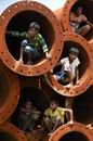 Boys Sitting in Piled Culvert