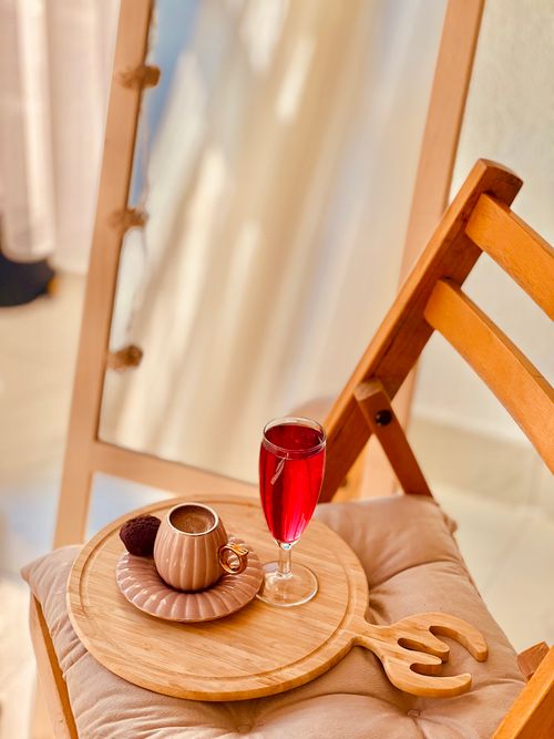 Free Warm, inviting indoor setup with coffee and red juice on a wooden tray next to a mirror. Stock Photo