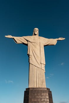 Iconic Christ the Redeemer statue under clear blue sky in Rio de Janeiro, Brazil.
