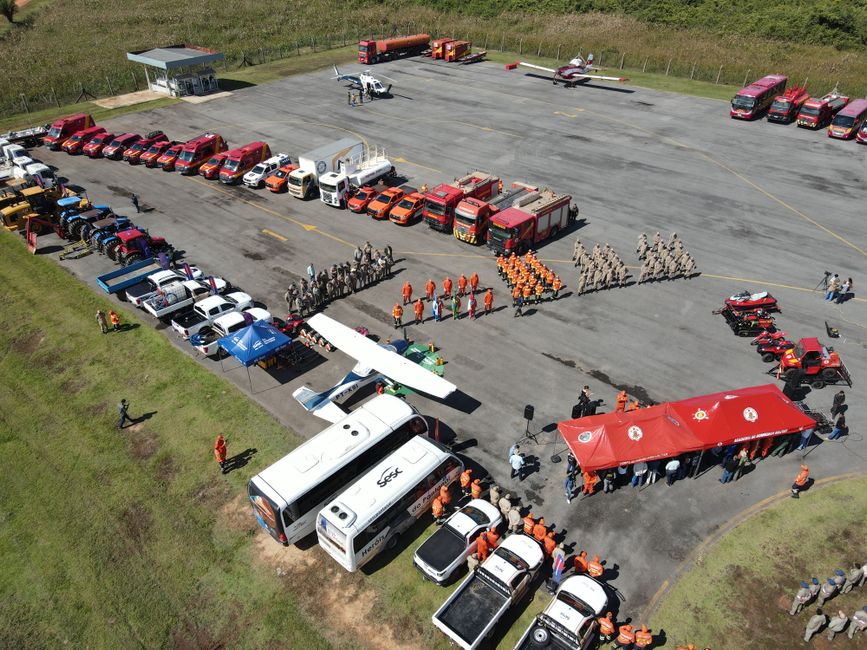 Aerial view of firefighters and equipment in training at an outdoor facility.
