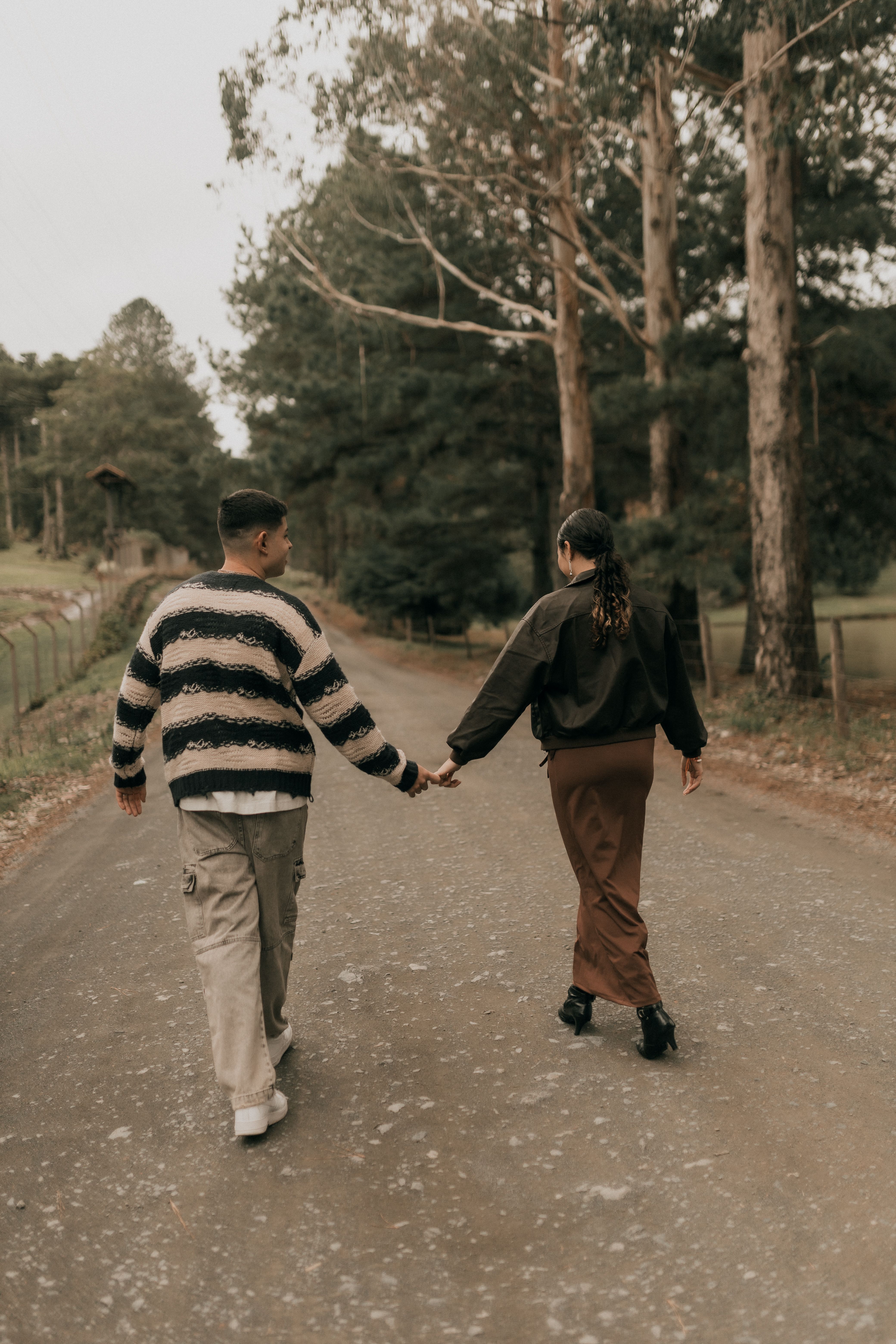 Couple Walking Hand in Hand on Forest Path · Free Stock Photo