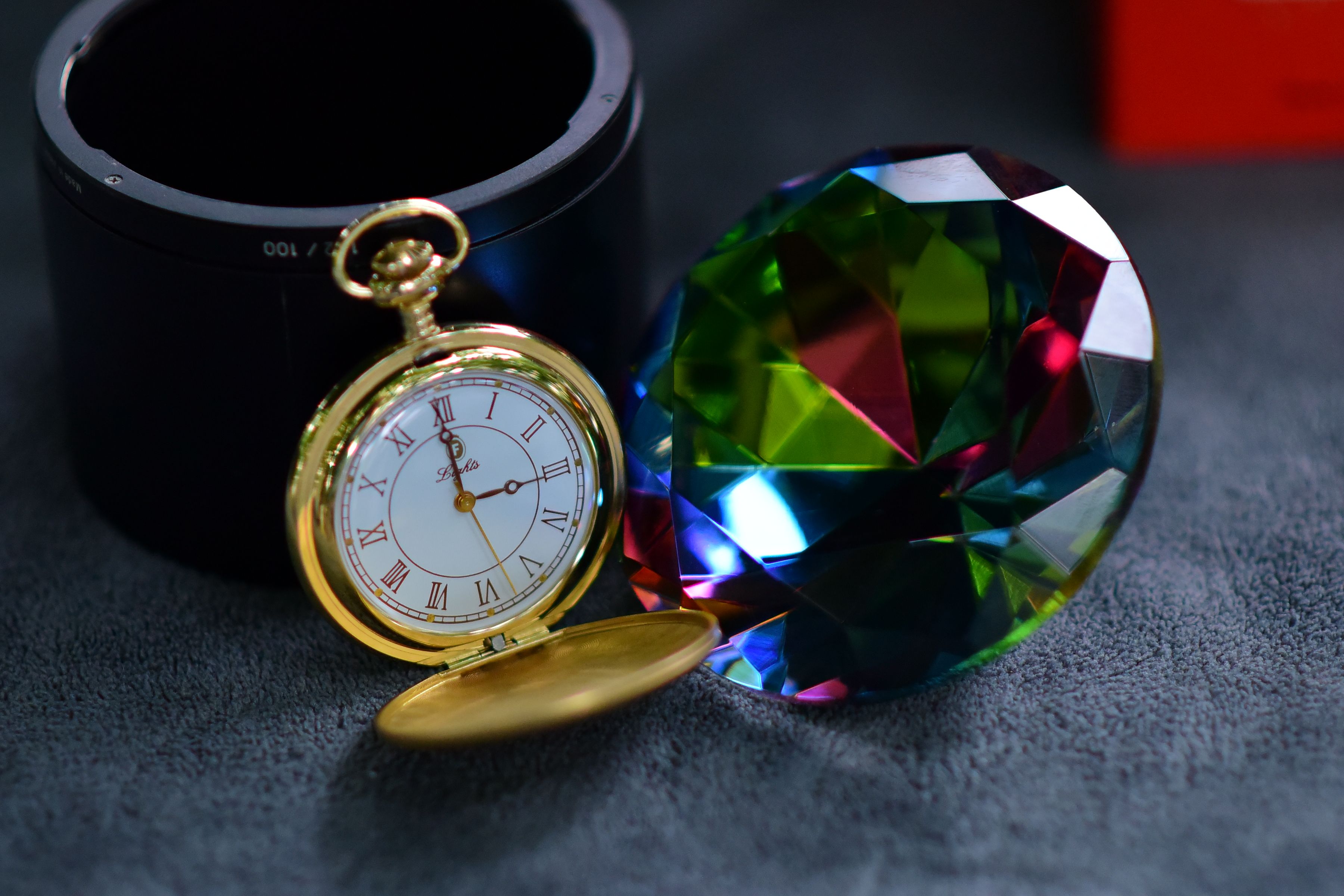 Elegant Gold Pocket Watch with Colorful Gem Reflection · Free Stock Photo
