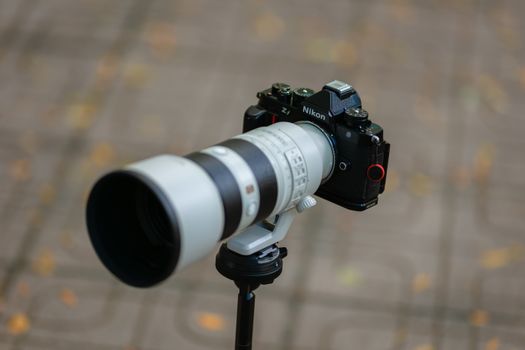 High-quality image of a professional camera with a telephoto lens, emphasizing photography equipment.