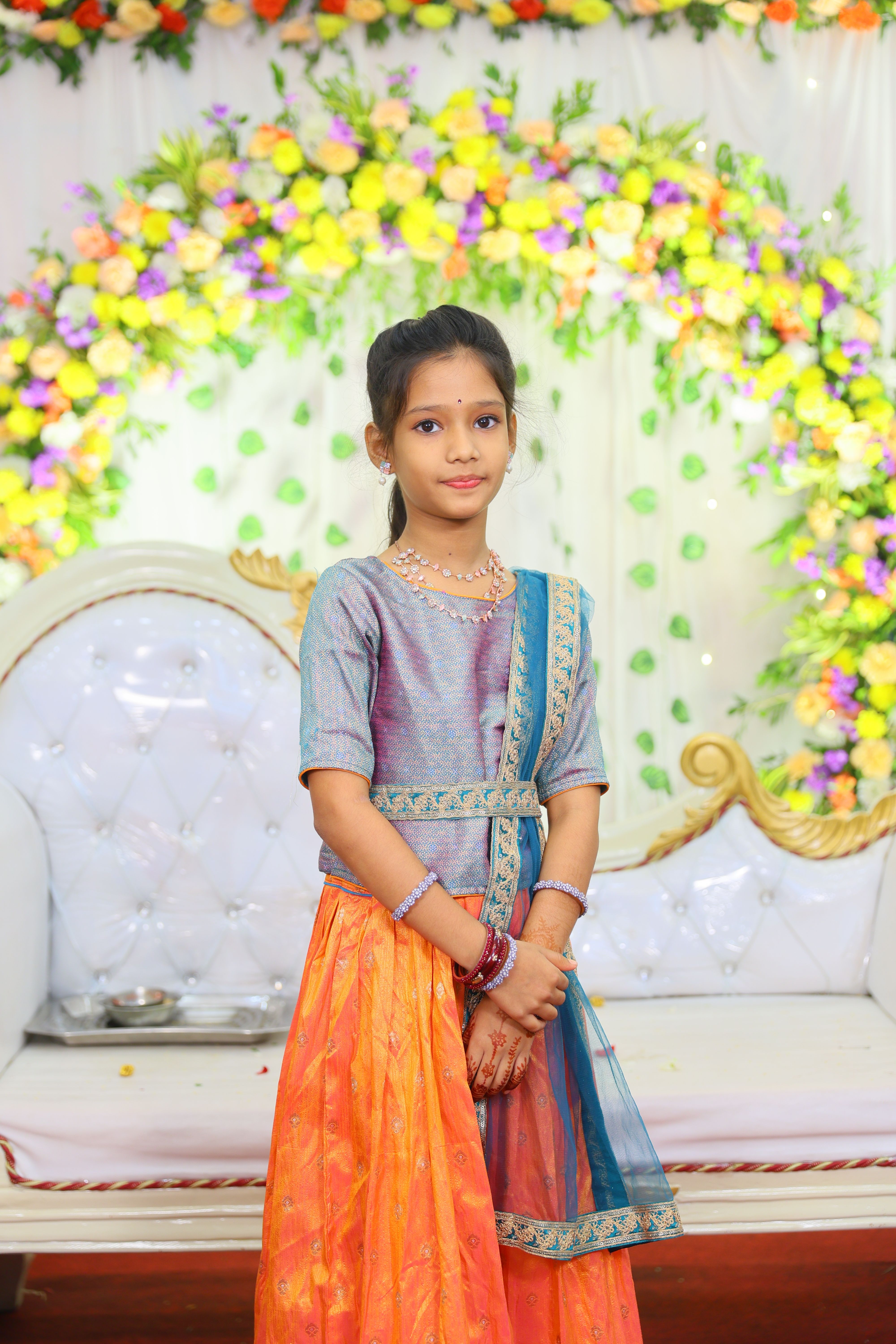 Half saree function decor with traditional floral backdrop