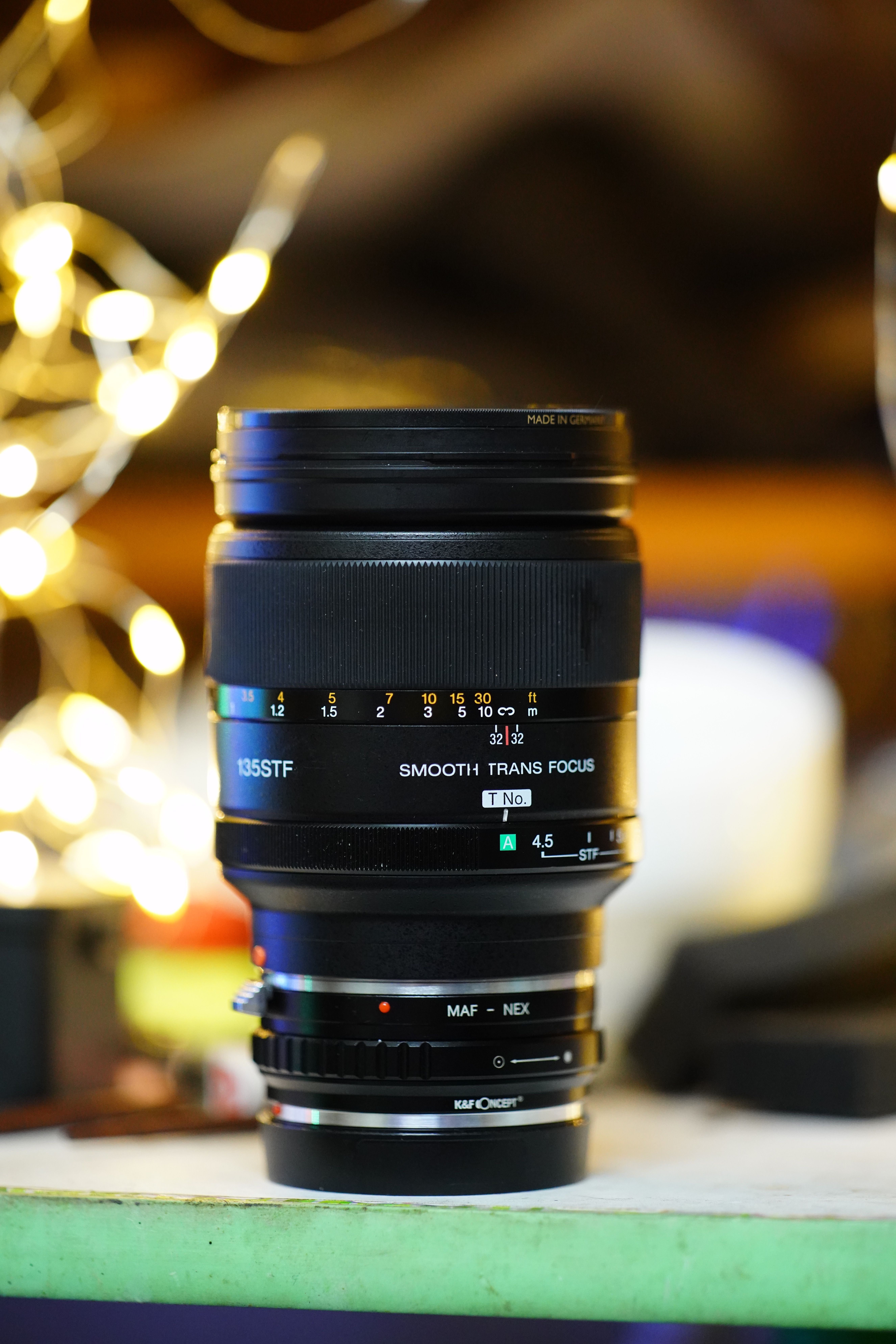 Detailed view of a camera lens with bokeh light background. Perfect for photography enthusiasts.