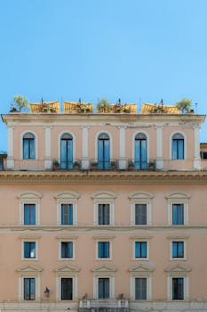 Charming European building with upper floor terraces and classic architecture.