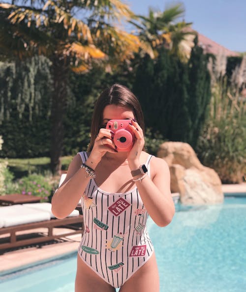 Free Woman Holding Pink Instant Camera Stock Photo