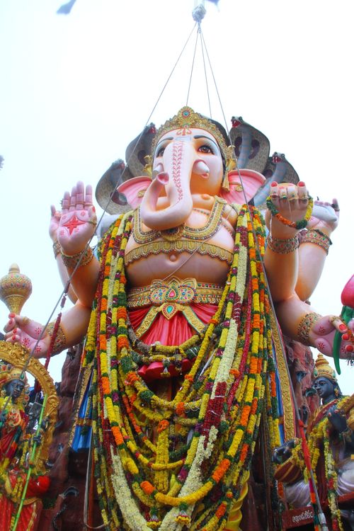 Free Intricate statue of Lord Ganesha adorned with colorful garlands and traditional ornaments. Stock Photo