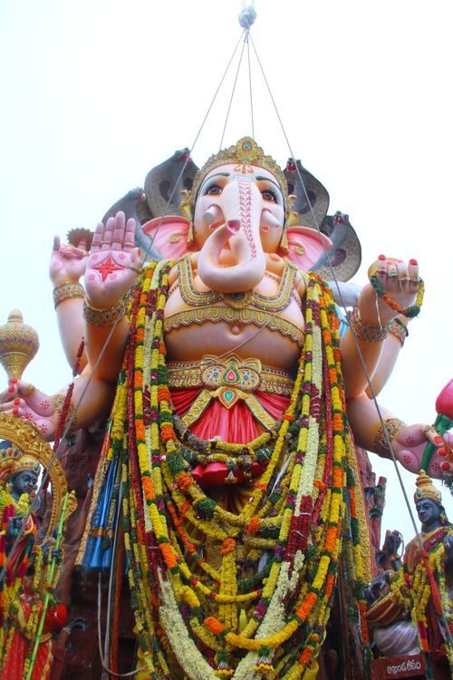 Free A stunning Ganesh idol adorned with colorful garlands, perfect for festive themes. Stock Photo