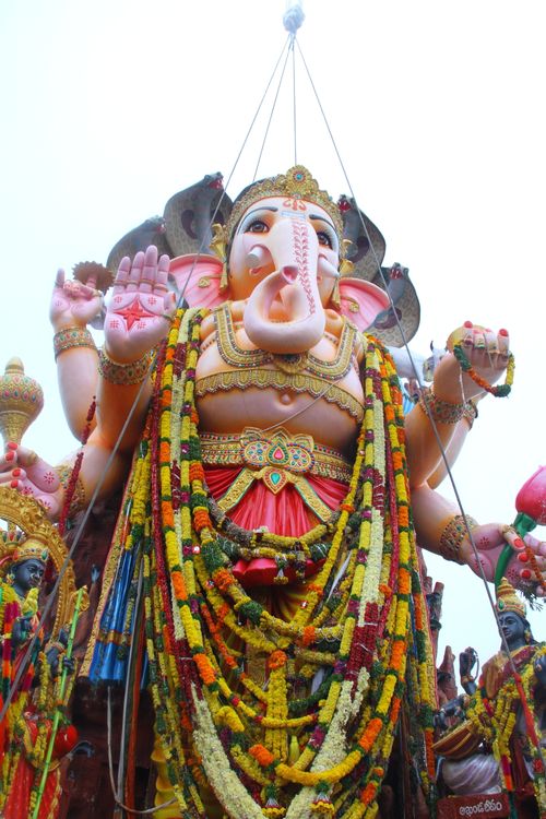 Free Vibrant Ganesha idol adorned with floral garlands at a festival celebration, embodying cultural richness. Stock Photo