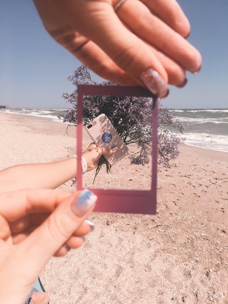 Mobile Phone And Bunch Of Flowers In Photo Frame