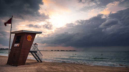 lifeguard house on sandy seashore in overcast day