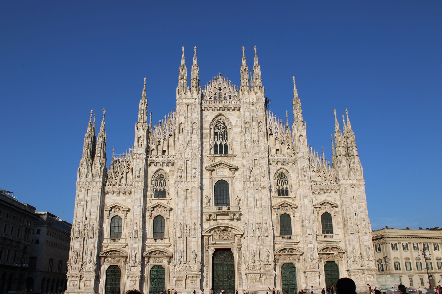Stunning view of Milan Cathedral showcasing gothic architecture under clear blue skies.