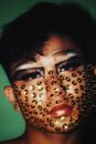 Person With Eye Makeup and Thumb Tacks on Face