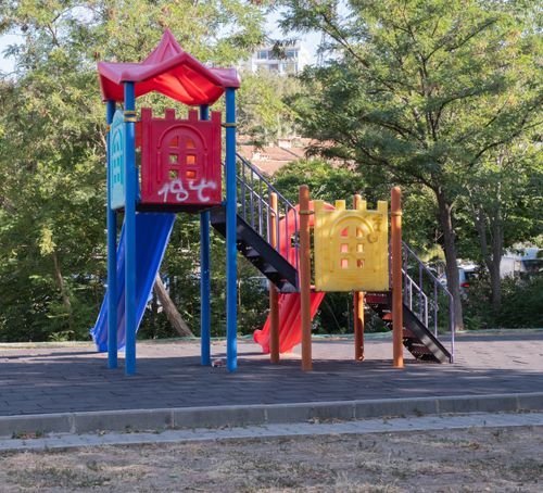 Free Vibrant playground equipment in a sunny İzmir park, ideal for kids' outdoor activities. Stock Photo